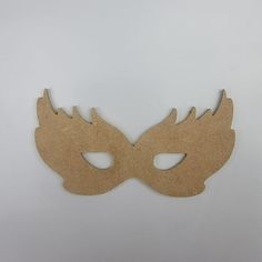 a wooden mask that is shaped like a bird