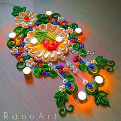 an intricately decorated diya with candles on the floor