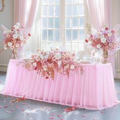 a table with pink and white flowers on it