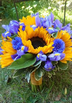 a bouquet of sunflowers and blue cornflowers