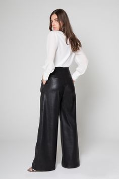 These wide-leg faux leather pants sit at your natural hip level. 85% Polyester 15% Pu Dry Clean Only Model is wearing size: S Made in the USA Model: Style: ADM6418 Black Faux Leather Wide Leg Pants Outfit, Wide Leg Leather Pants Outfit, Wide Leg Leather Pants, Leather Wide Leg Pants, 50 Plus Fashion, Wide Leg Pants Outfit, Leather Pants Outfit, Wardrobe Wishlist, Leather Pant