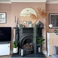 a living room filled with furniture and a fire place in front of a flat screen tv