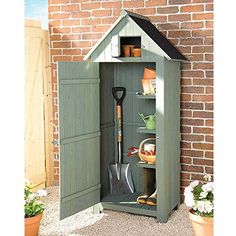 an outdoor garden shed with gardening tools in the door and shelves on the outside wall