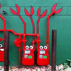 two red fire hydrants with funny faces on them, and the same one has been painted