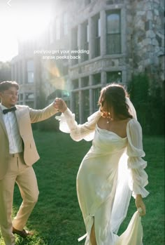 a bride and groom are dancing in the grass