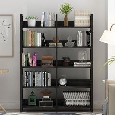 a bookshelf filled with lots of books in a living room next to a lamp