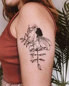 a woman with a flower tattoo on her arm, holding onto a plant and wearing a red tank top