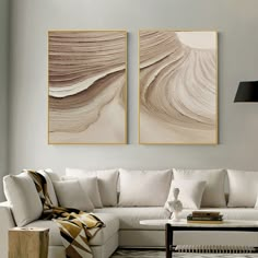 a living room with two paintings on the wall