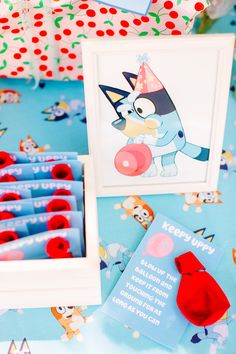 a birthday party with blue and red items on the table, including an image of a cat