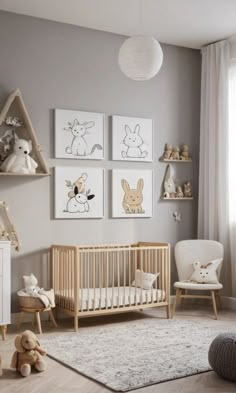 a baby's room with grey walls and pictures on the wall