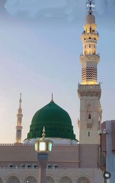 a tall white building with a green dome