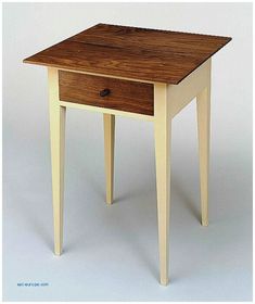 a small wooden table with one drawer on the top and two legs at the bottom