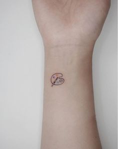 a small tattoo on the wrist of a person