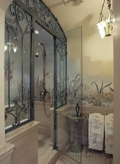 an ornately decorated bathroom with glass shower doors