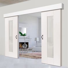 an open door leading to a living room with white walls and furniture in the background