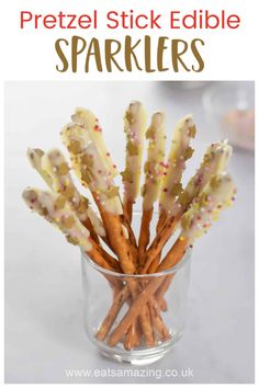 a glass filled with lots of pretzels sitting on top of a white table