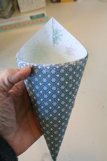 a person is holding an origami piece in their hand