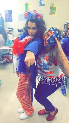 two girls dressed in patriotic costumes pointing at the camera