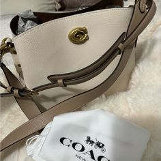 Coach Bag Cream Shoulder Bag With Dust Bag For On-the-go, Cream Shoulder Bag For On-the-go, Elegant Coach Shoulder Bag For Everyday, Coach Beige Shoulder Bag With Dust Bag, Beige Coach Shoulder Bag With Dust Bag, Elegant Coach Bucket Bag With Removable Pouch, Chic Coach Bag With Detachable Handle, Chic Coach Bucket Bag For Daily Use, Chic Coach Tote Satchel