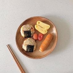 sushi and vegetables on a plate with chopsticks