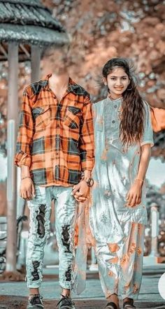 two people standing next to each other in front of a gazebo