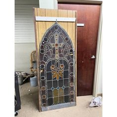 an old stained glass door in front of a wooden door