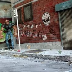 a man standing in front of a building with graffiti on it