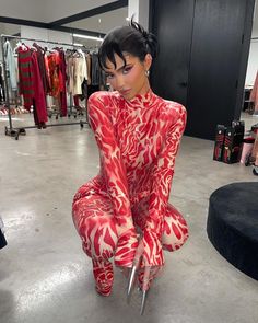 a woman in red and white outfit holding scissors