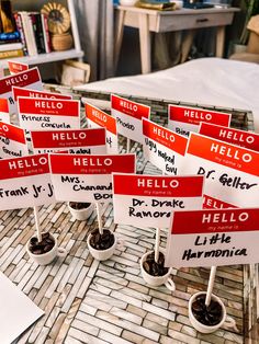 small red and white signs sitting on top of a brick floor next to potted plants