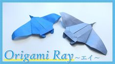 two origami airplanes sitting side by side on a white surface with the words origami ray written below it