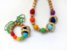 two crocheted wooden beads are attached to necklaces