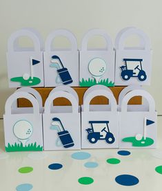 several golf themed gift bags are stacked on top of each other in front of a polka dot tablecloth