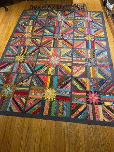 a large quilt is laying on the floor