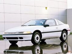 a white car parked in front of a building