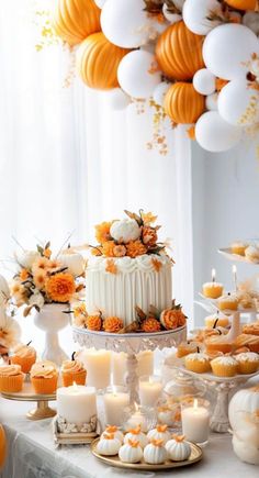 a table topped with lots of cakes and cupcakes