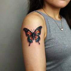 a woman with a butterfly tattoo on her arm