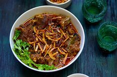 two bowls filled with food sitting on top of a table