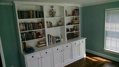 an empty room with bookshelves and cabinets in it