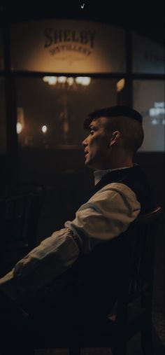 a man sitting in a chair looking off into the distance