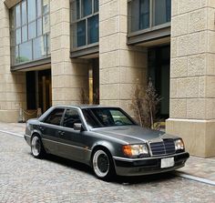 a car parked on the street in front of a building