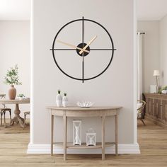 a living room with a table and clock on the wall