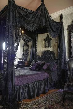 an ornate canopy bed in a bedroom with purple and black decor on the walls, along with antique furniture