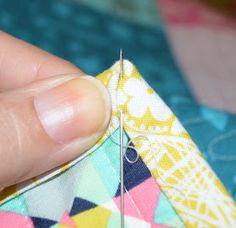 someone is stitching the end of a piece of fabric