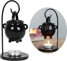 a black tea light holder with a candle in it and an image of a pot on a stand