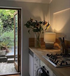 a vase with sunflowers sitting on top of a counter next to a window