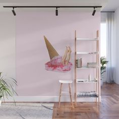 a pink wall with an ice cream cone on it and a woman's legs sticking out