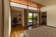 a bedroom with hardwood floors and sliding glass doors