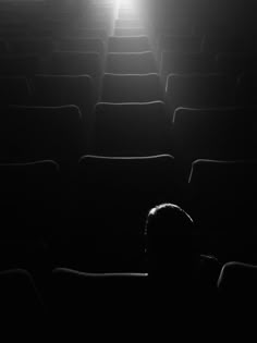 a person is sitting in an empty theater