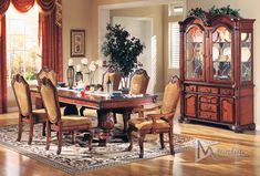 a formal dining room table with chairs and china cabinet