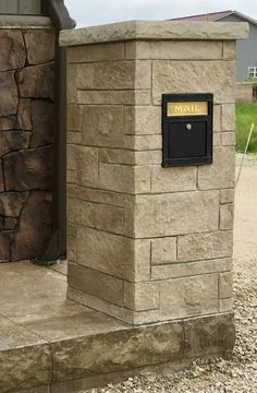 a mailbox on the side of a stone building